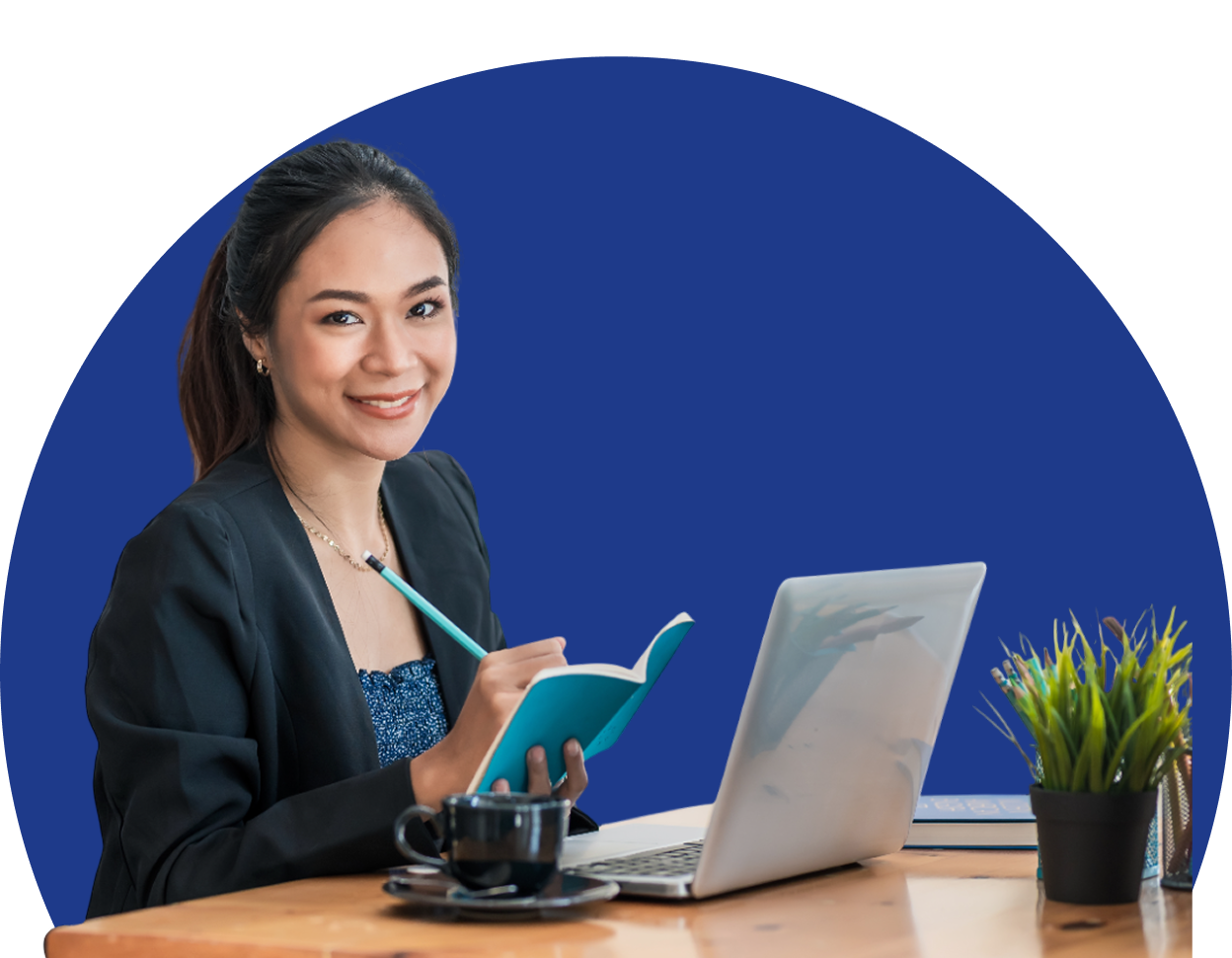 Woman working at desk with laptop.